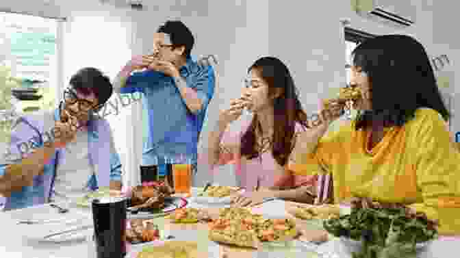 A Group Of People Enjoying A Healthy Meal Together, Smiling And Laughing Water Intermittent Fasting Guide: The Right Way To Implement This Lifestyle Change: What Is Waterless Fasting